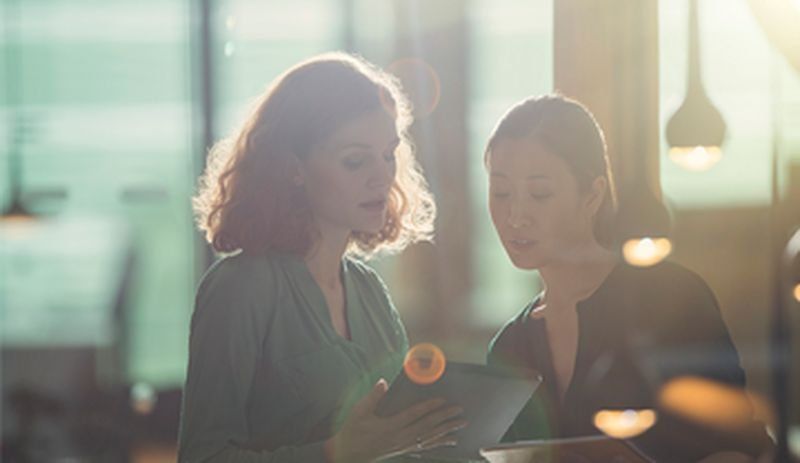 Two women looking at a tablet